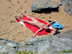 Nude girl on beach sunning.