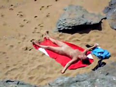 Nude girl on beach sunning.