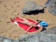 Nude girl on beach sunning.