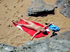 Nude girl on beach sunning.