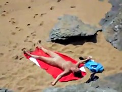 Nude girl on beach sunning.