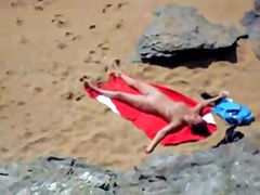 Nude girl on beach sunning.