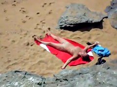 Nude girl on beach sunning.