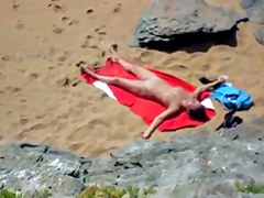 Nude girl on beach sunning.