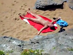 Nude girl on beach sunning.
