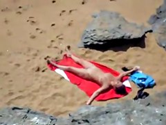 Nude girl on beach sunning.