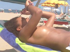 Topless ebony teen on the beach
