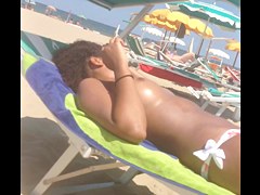Topless ebony teen on the beach