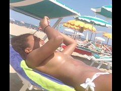 Topless ebony teen on the beach