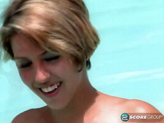 Aliha Aldamen tans her fair skin outside by the pool while wearing a blue and white striped bikini before masturbating on the deck.