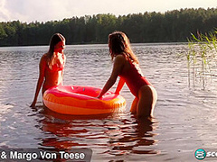 Margo Von Teese and Simona splash each other in their bikinis in a lake before eating each other out on the beach.