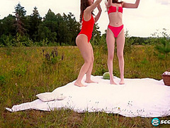 Margo Von Teese and Simona splash each other in their bikinis in a lake before eating each other out on the beach.
