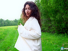 Busty teenage brunette Lola exposes her DD-cup tits in an open field and spreads her pussy for your pleasure.