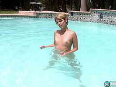 Aliha Aldamen tans her fair skin outside by the pool while wearing a blue and white striped bikini before masturbating on the deck.