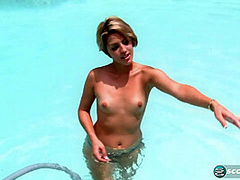 Aliha Aldamen tans her fair skin outside by the pool while wearing a blue and white striped bikini before masturbating on the deck.