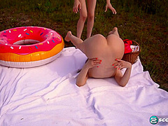 Margo Von Teese and Simona splash each other in their bikinis in a lake before eating each other out on the beach.