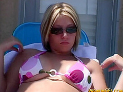 Paige lotions up outdoors under the sunshine