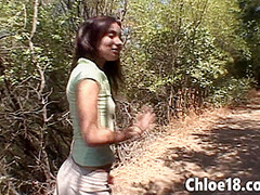 Teen enjoying the great outdoors while fingering her pussy