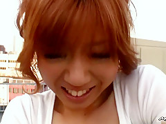 This Asian red head is up on a public rooftop getting nasty with