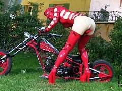 Latex Lucy in latex suit is fingering cunt