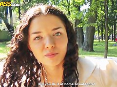 Cute curly brunette Leonora shows her boobs in park