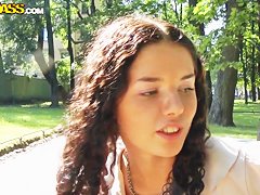 Cute curly brunette Leonora shows her boobs in park