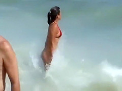 Girl with a sexy bikini enters the water