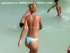 Girl with a sexy bikini enters the water