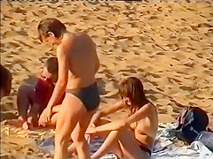 Nudist family leaving the beach