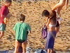 Nudist family leaving the beach