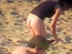 Nudist family leaving the beach