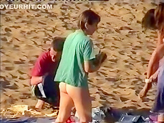 Nudist family leaving the beach