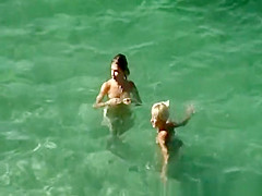 Nudists swimming in the beach