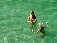 Nudists swimming in the beach
