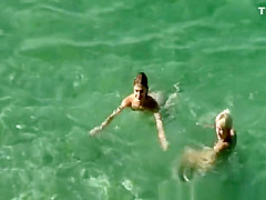 Nudists swimming in the beach