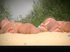 Two nudist girls sunbathing