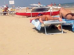 Round ass woman in orange bikini