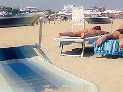 Round ass woman in orange bikini