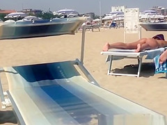 Round ass woman in orange bikini
