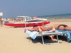 Round ass woman in orange bikini