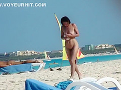 Mature nudist lady puts lotion on herself