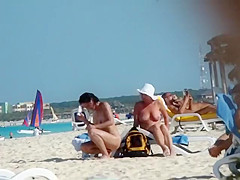 Mature nudist lady puts lotion on herself