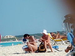 Mature nudist lady puts lotion on herself