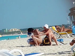 Mature nudist lady puts lotion on herself