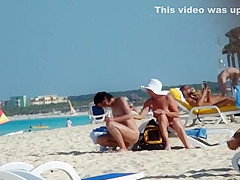 Mature nudist lady puts lotion on herself