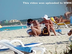 Mature nudist lady puts lotion on herself