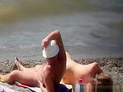 Busty nudist woman sprays her man's back