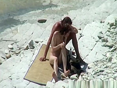 Nudist couple sunbathing and refreshing