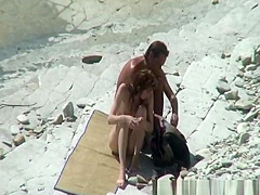 Nudist couple sunbathing and refreshing