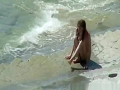 Nudist couple sunbathing and refreshing